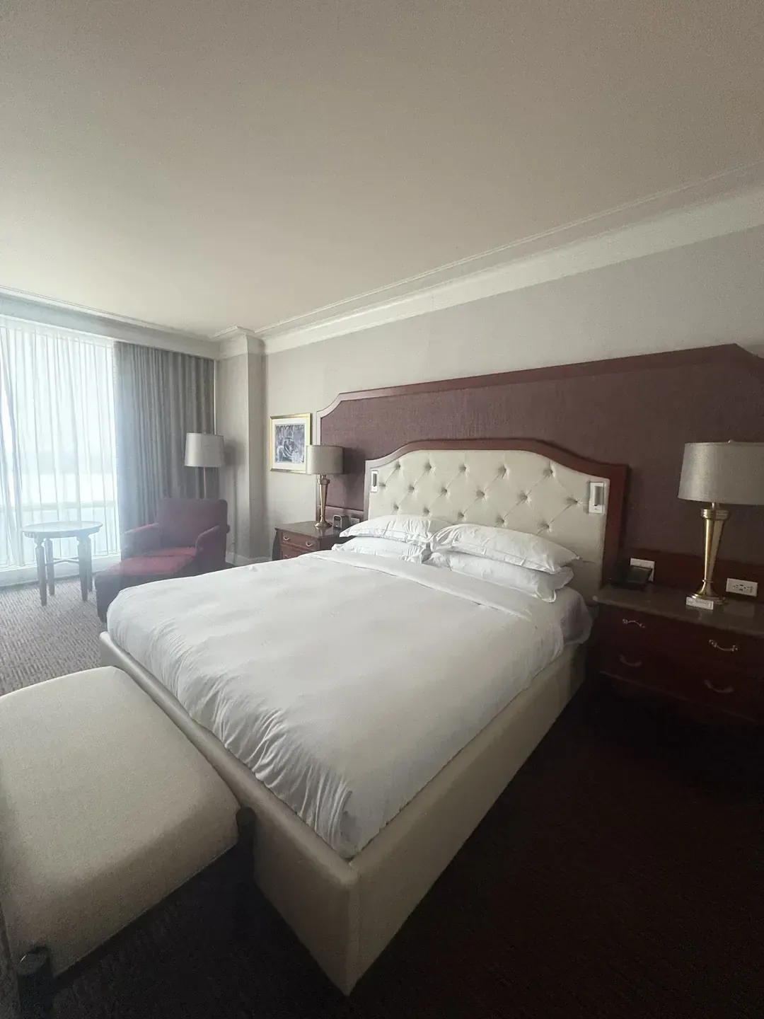 A prepared guest room at Hilton Lac-Leamy in Gatineau, with a tufted headboard and a curtained window